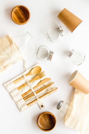 Zero waste set with recycled tableware, cotton bag, glass jars on white desk, top view. Plastic free, eco friendly concept.の写真素材