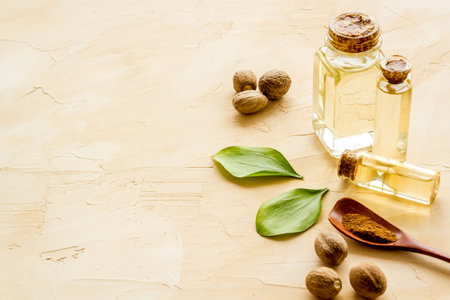 Nutmeg oil - perfume ingredient - on beige background.の写真素材