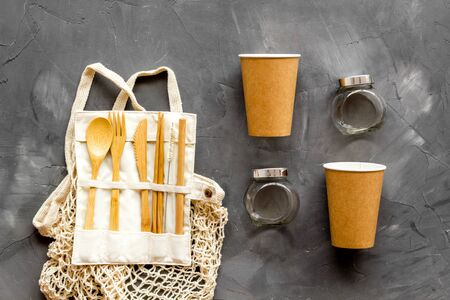 Set of reusable items for eco-friendly lifestyle. Cotton bag, glass jars, wooden tableware. Zero waste, organic shopping concept. Gray background, top downの写真素材