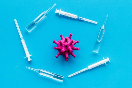 Corona virus Covid-19 - vaccine concept with syringe - on blue background top-downの写真素材