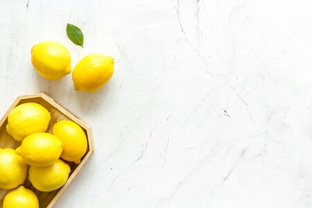 Ripe lemons in tray on white backgroud top-down.の写真素材
