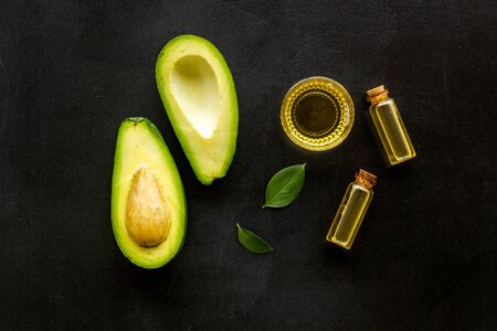 Avocado oil - ingredient for cosmetics - on black background top-downの写真素材