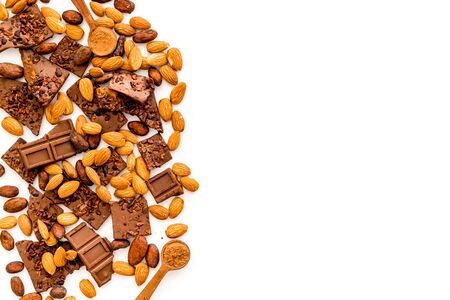Chocolate frame. Broken slices and nuts on white background top-down.の写真素材