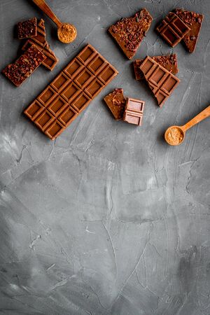 Homemade chocolate. Bars and broken pieces on grey stone table frame copy spaceの写真素材