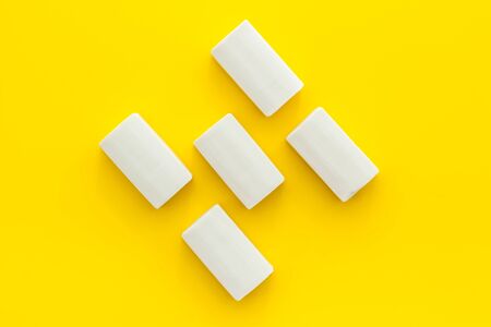 Soap bars flat lay on yellow background top-down.の写真素材