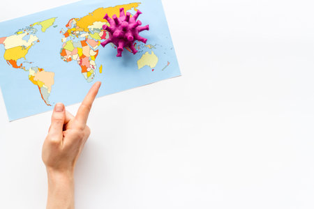 Corona virus Covid-19 - epidemic concept with world map, hand shows focus of disease - on white...