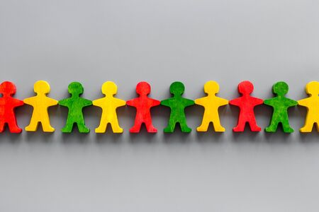 Set of wooden people figures on gray desk. Human resources, management, hiring concept top viewの写真素材
