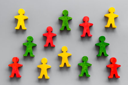 Tolerance in society, human rights, anti-discrination concept. Wooden figures of people on gray...