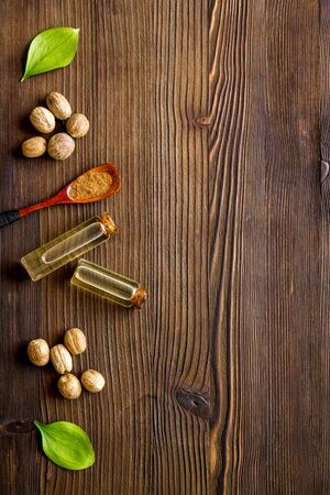Nutmeg oil - perfume ingredient - on wooden background top-down copy spaceの写真素材
