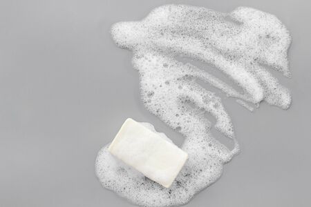 Soap bar with foam on grey background top-down copy spaceの写真素材