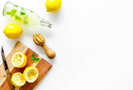 Make lemonade. Drink in bottle near utensil on white background top-down.の写真素材