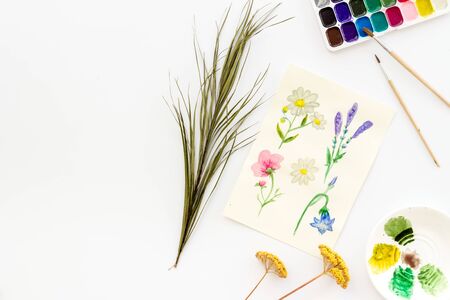 Drawing flowers with watercolor paintis on white background top-down.の写真素材