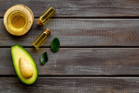 Avocado oil - ingredient for cosmetics - on woode background top-down.の写真素材
