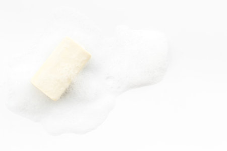 Soap bar with bubbles on white background top-downの写真素材
