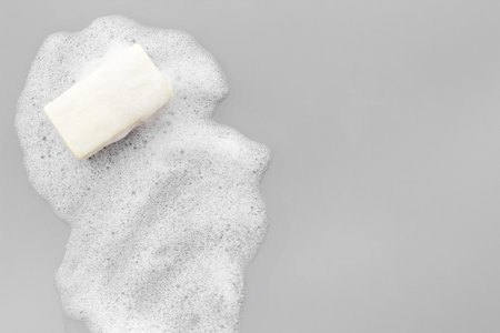 Soap bar with foam on grey background top-down copy spaceの写真素材