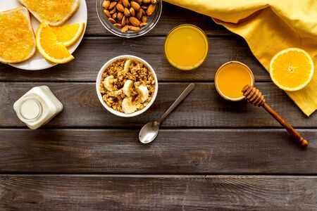 Vegetarian breakfast with granola and fruits on wooden background top-down frame copy spaceの写真素材
