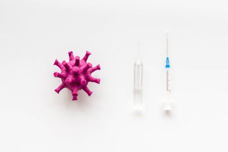 Corona virus Covid-19 - vaccine concept with syringe - on white background top-down patternの写真素材