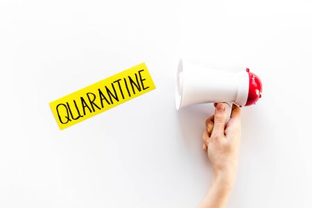 Quarantine announcement in world. Megaphone on white background top viewの写真素材