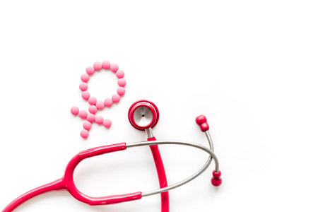 Womens Health issues. Medical concept with Venus sign and stethoscope on white background top-down copy spaceの写真素材