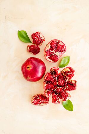 Cut pomegranate with ripe seeds on beige background top-downの写真素材