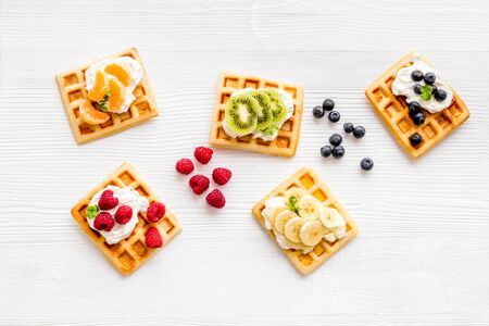 Breakfast with freashly baked belgian waffles on white background top-down frame copy spaceの写真素材