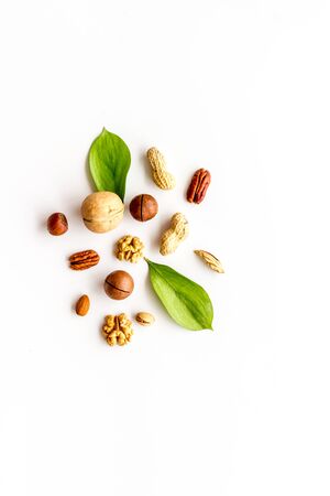 Nuts background - healthy snacks concept - on white table top-down.の写真素材