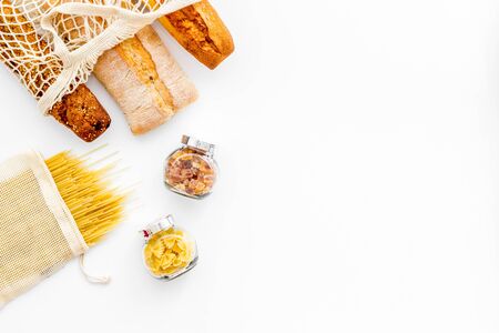 Eco bag, glass jars on white background, top view. Zero waste food storage concept copy spaceの写真素材