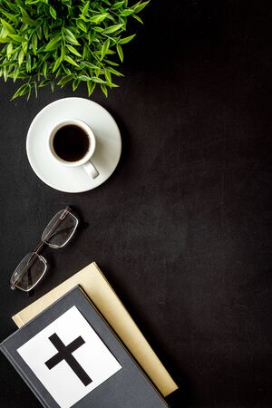 Holy Bible book with catholic cross - catholicism religion concept - on black background top view. Copy spaceの写真素材