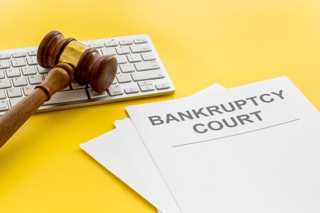 Bankruptcy court concept with gavel, document, keyboard on wooden backgroundの写真素材
