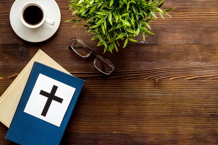 Holy Bible book with catholic cross - catholicism religion concept - on wooden background top view. Copy spaceの写真素材