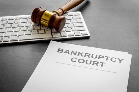 Bankruptcy court concept with gavel, document, keyboard on wooden backgroundの写真素材