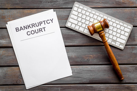 Bankruptcy court concept with gavel, document, keyboard on wooden background top-down mockupの写真素材