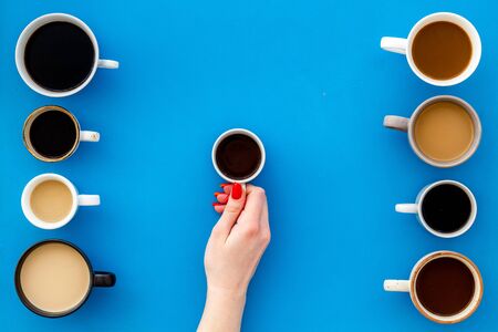Many cups of coffee on blue background top view.の写真素材