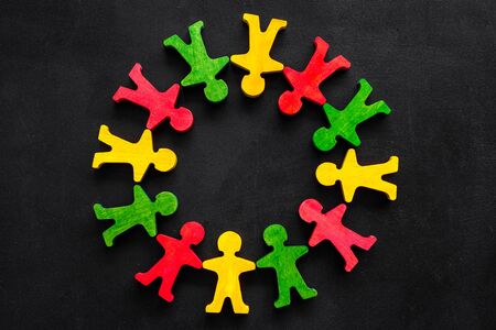 Tolerance, social protection, anti-discrimination concept. Wooden human figures on black table, top viewの写真素材