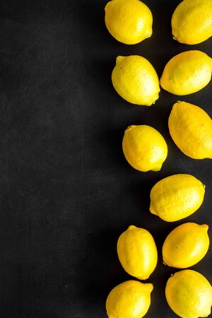Lemons frame. Whole fruits on black backgroud top-down .の写真素材