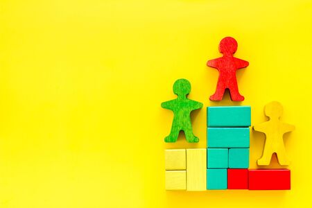 Winners podium. Figures of humans on yellow desk top-down space for textの写真素材