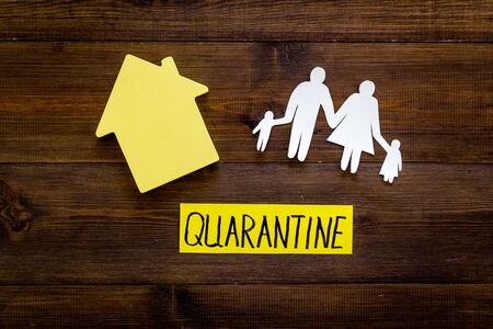 Quarantine stay at home - isolation, prevention. House and family on wooden table top viewの写真素材