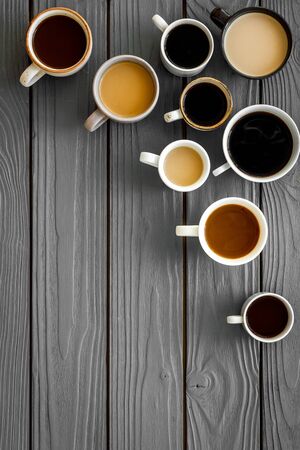 Lots of coffee on wooden desk top-down.の写真素材