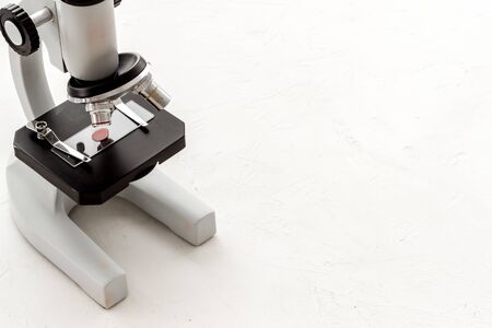 Bood testing with microscope in laboratory. Equipment on white background copy space