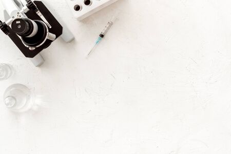 Microscope medical reserch. Blood sample for analysis. White table top view copy spaceの写真素材
