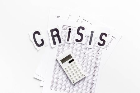 Financial crisis concept with calculator on white background top viewの写真素材