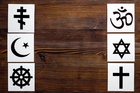 World religions concept. Christianity, Catholicism, Buddhism, Judaism, Islam symbols on wooden...