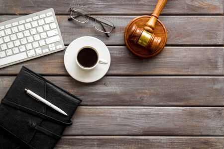 Judge gavel near documents and keyboard - lawyer concept - on wooden background top-down copy spaceの写真素材