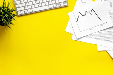 World financail crisis - arrow down, markets crash - on yellow office desk top view.