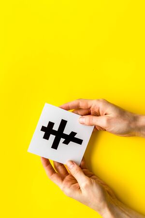 Ortodox cross in hands - Christianity symbol - on yellow background top-down copy spaceの写真素材