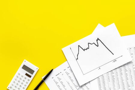 World financail crisis - arrow down, markets crash - on yellow office desk top view space for textの写真素材