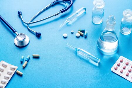 Treatment of influenza or cold. Medicine, stethoscope on blue table copy spaceの写真素材