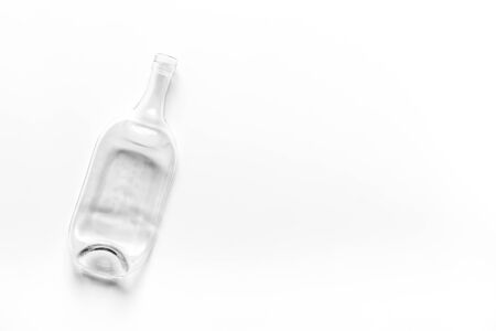 White empty wine bottle on white table top-down.の写真素材