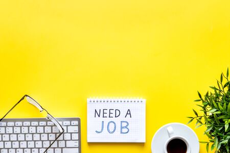 Need a job, looking for. Text on yellow office desk top-down space for textの写真素材