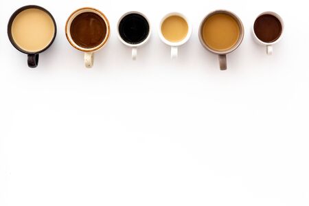 Cups of hot drinks on white background from above frame copy spaceの写真素材